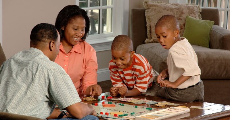Família unida a jogar um jogo de tabuleiro