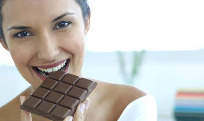 Mulher a comer chocolate negro